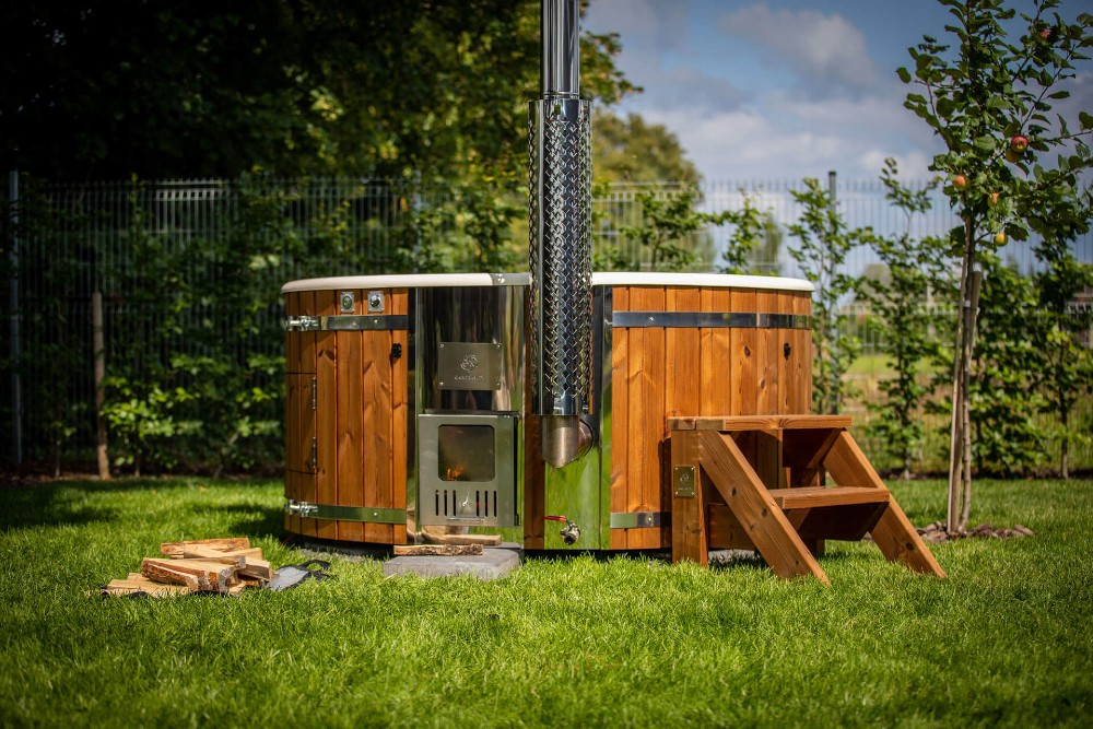 Wood burning hot tub in the garden in summer