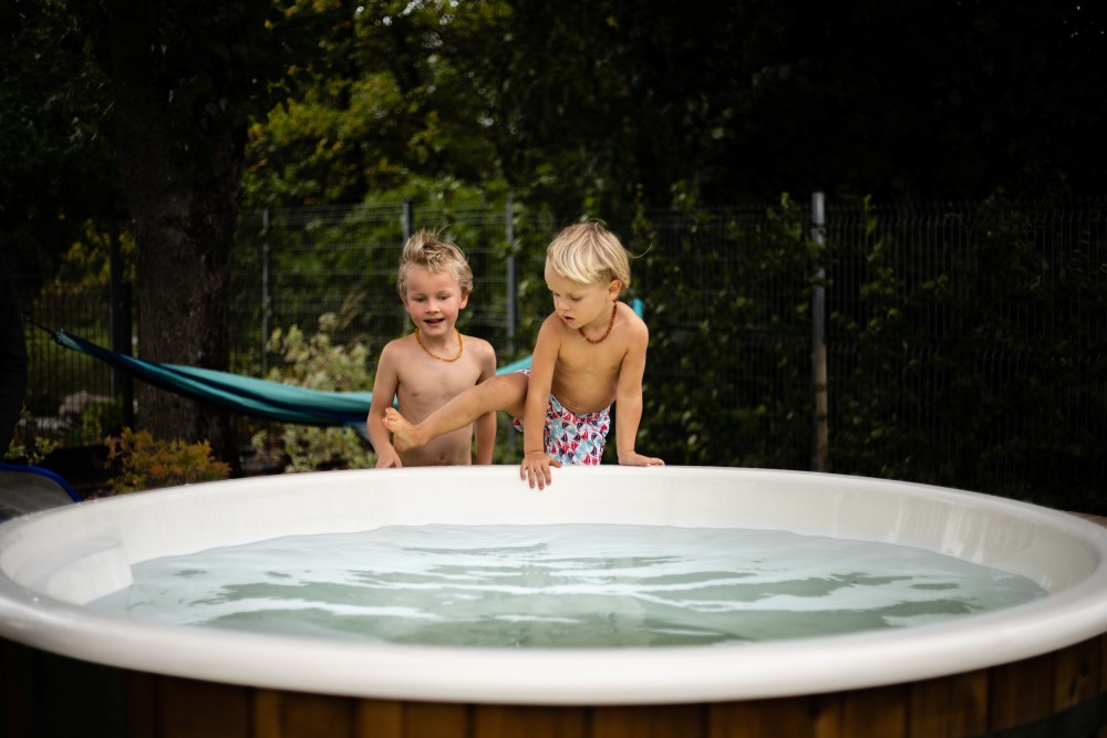 two boys going to log burning hot tub